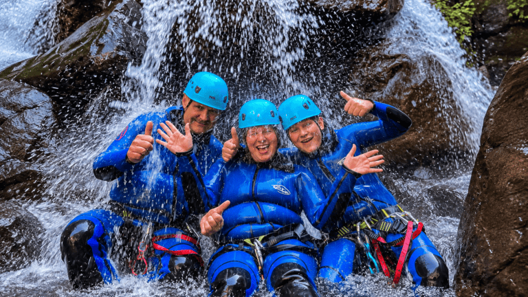 Group canyoning at a waterfall in Madeira