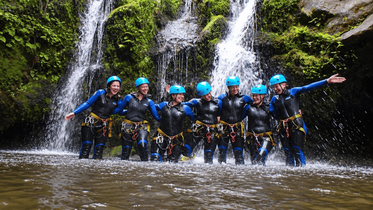 Canyoning group at a waterfall surrounded by Madeira's nature