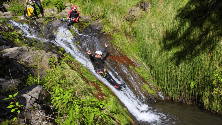 Natural water slide during a canyoning tour in Madeira
