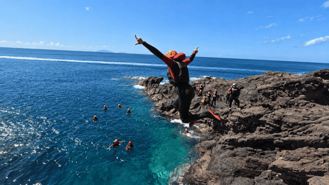 Cliff jump during a coasteering tour in Madeira